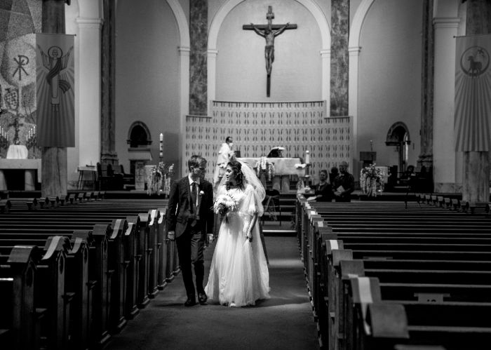 Canadian Wedding Photographer image of a Bride and Groom leaving Church.