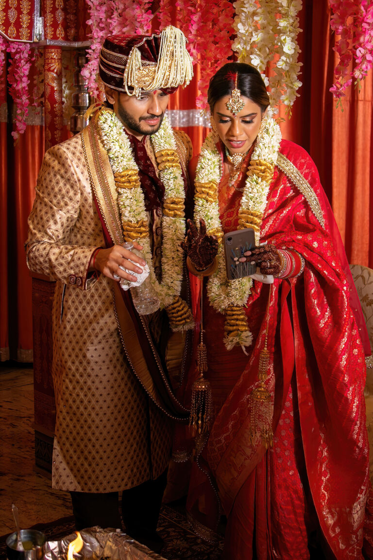 Indian wedding photography. Bride and Groom zoom meeting.