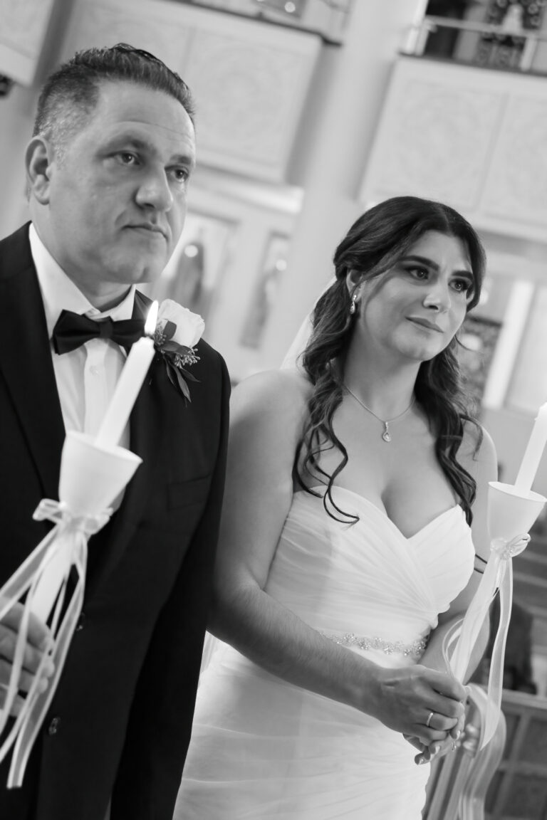 Greek Wedding Ceremony image. Bride and Groom with candles.