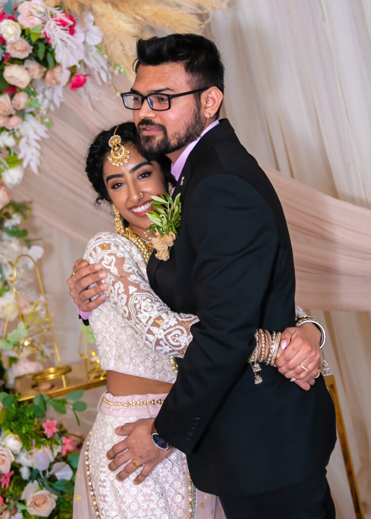 Formal Indian Wedding photography pose. Young Couple big hug and embrace.