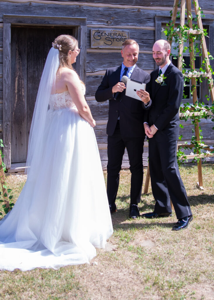 Wedding Photos. Bride with Groom and Officiant. Grooms Vows.