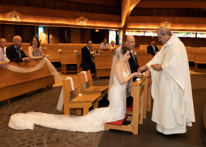Oakville Wedding Photography. Bride and Groom receive First Communion.